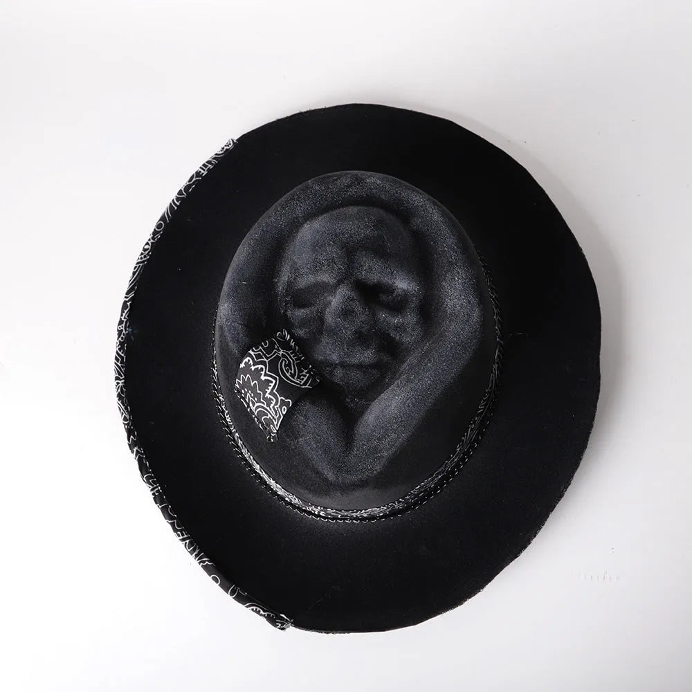 Handmade wool felt skull hat with a conical crown on a neutral background