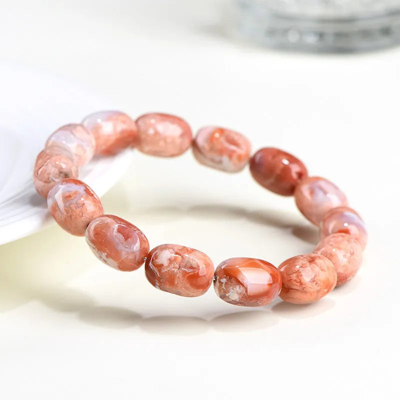 Natural cherry agate barrel bead bracelet with ruyi design elements measuring 10x14mm