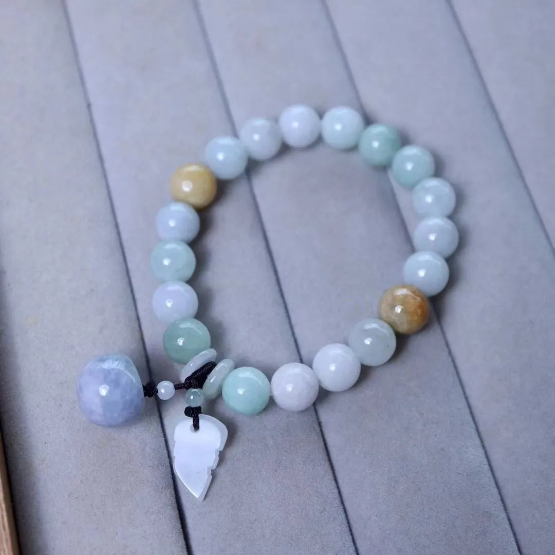 Natural emerald jade geometric bracelet with Maitreya Buddha, apple, and money bag hanging charms.
