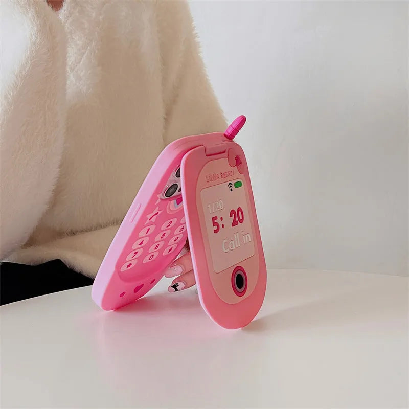 Pink silicone flip phone shape case with a mirror, designed for iPhone models.