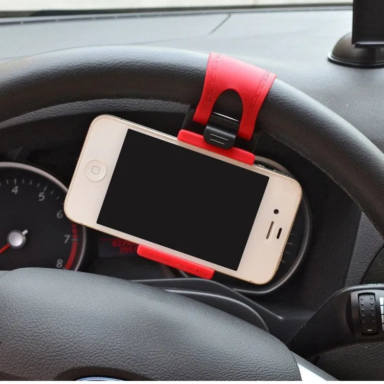 Black steering wheel phone holder clip mounted on car steering wheel holding a smartphone