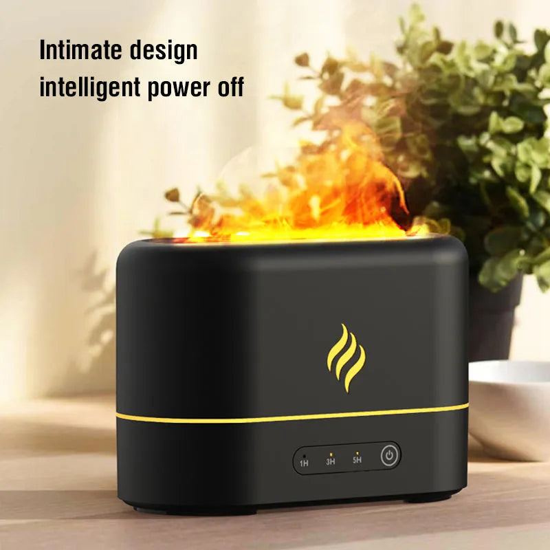 Black USB humidifier displaying a seven-colour flame effect on a desk next to a plant.