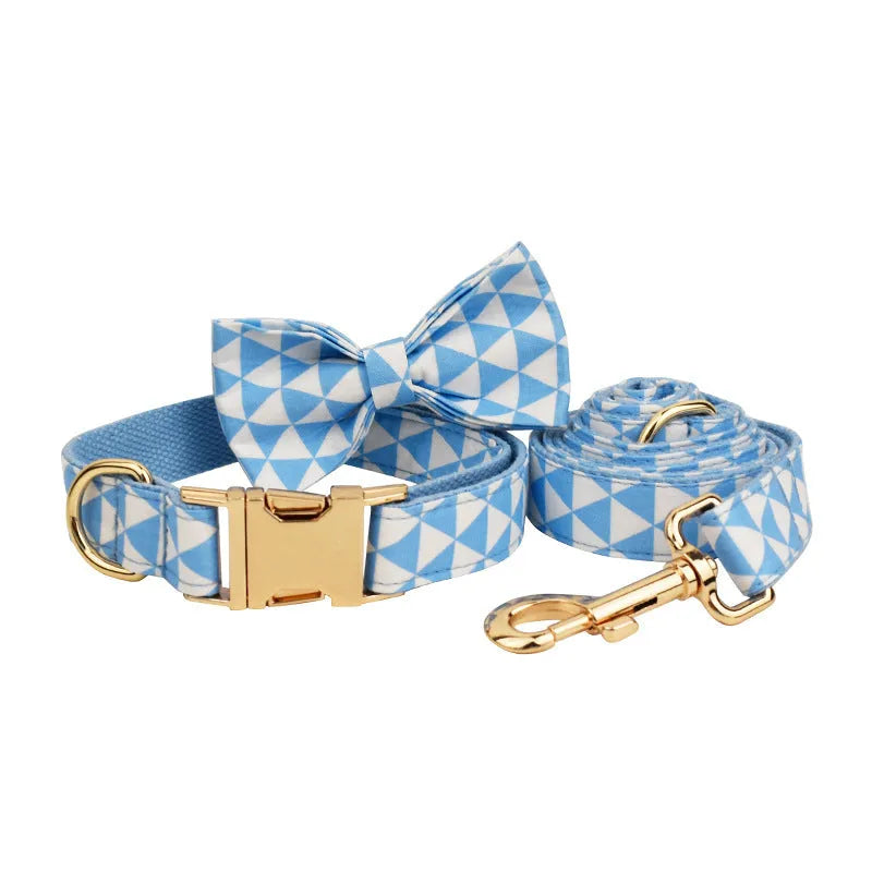 Blue triangular pattern dog harness set with matching leash, collar, and fabric bow accessory