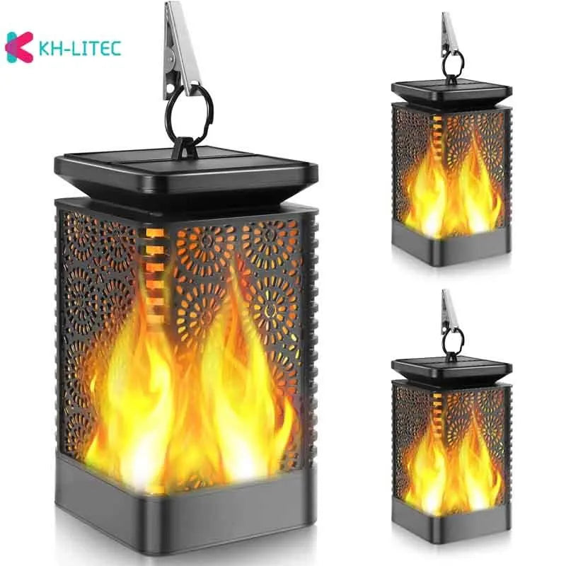 Black solar-powered hanging lantern with flickering LED flame light effect for garden decoration.