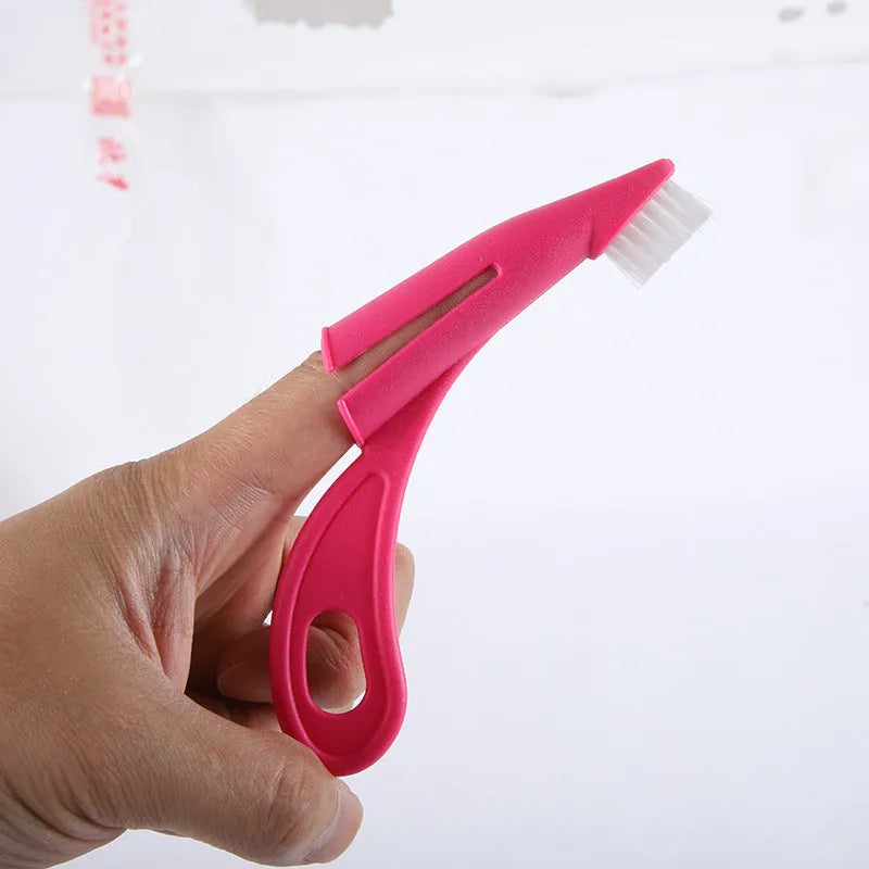 Red and white pet finger toothbrush with soft silicone bristles and a finger sleeve for cleaning dog or cat teeth.