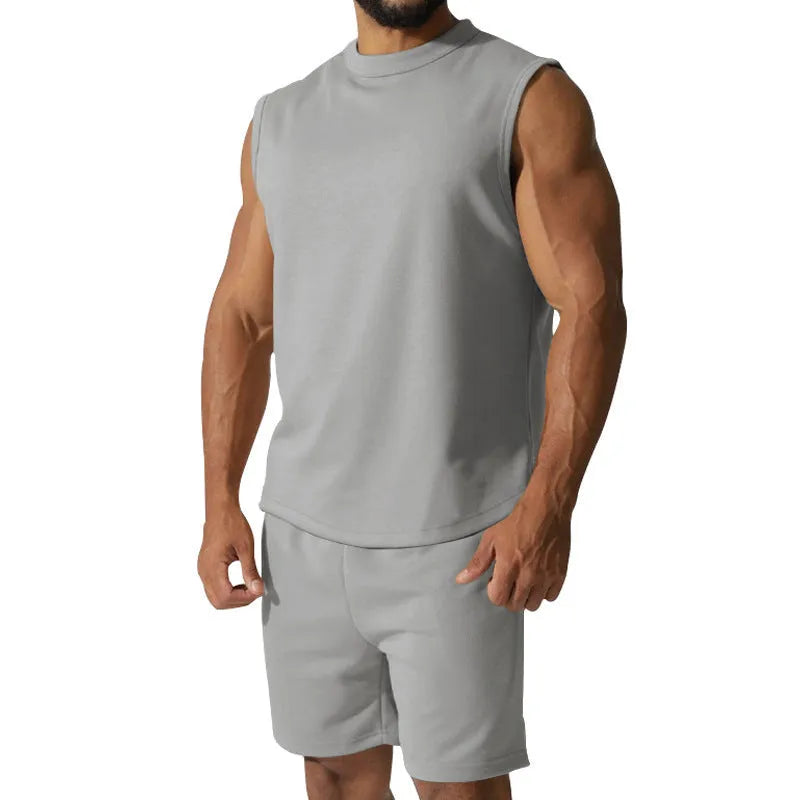 Men's sleeveless cotton blend sports top and shorts set in a solid colour.