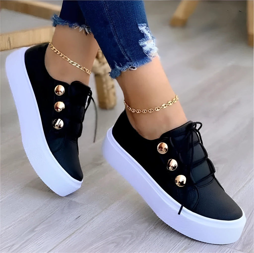 Women's lace-up flats sneakers with rivet detail, artificial PU upper, round toe, and polyurethane sole in white, black, gold, or rose gold.