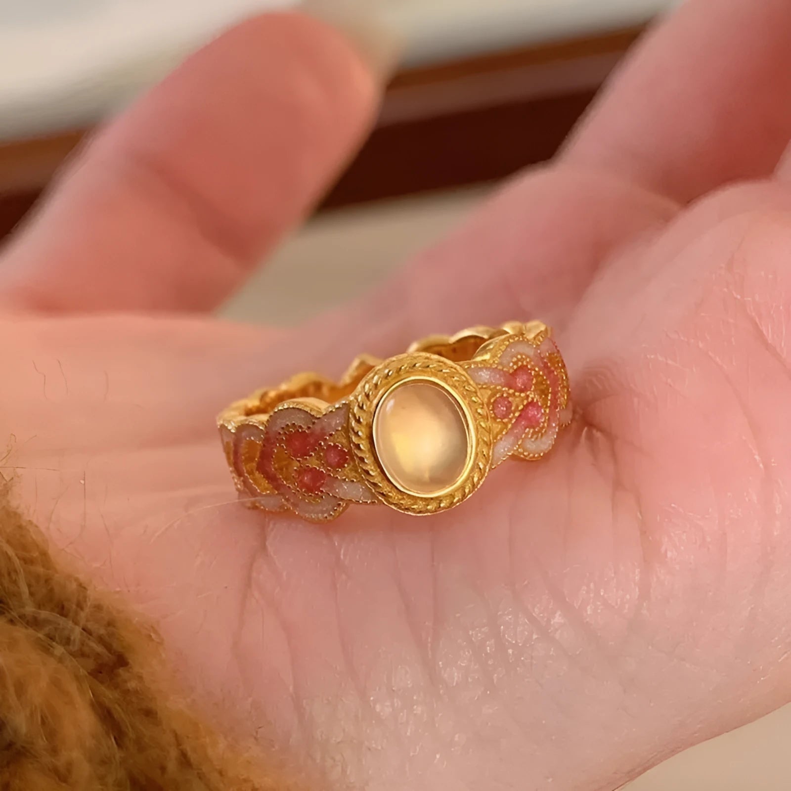 Geometric pink crystal enamel open ring for women on a copper band with gold plating.