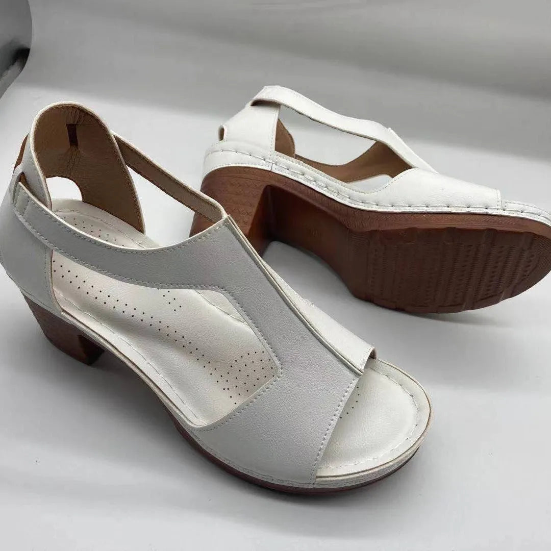 Plus size women's beige open toe wedge sandals with a buckle strap and low heel on a white background.
