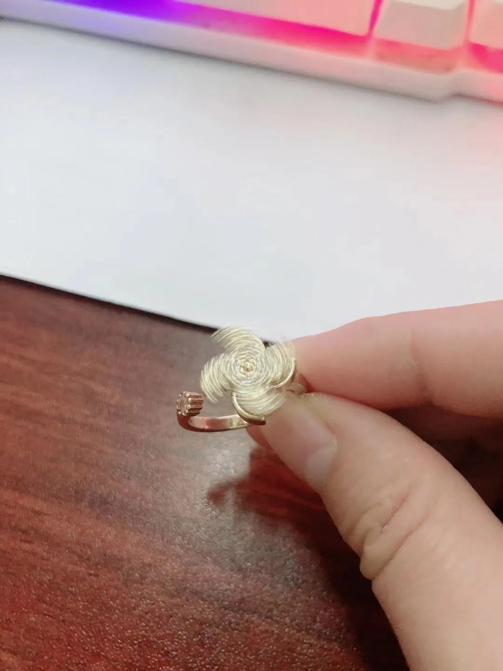 Rotating windmill ring showing golden electroplated finish on copper with geometric shape and micro inlaid design