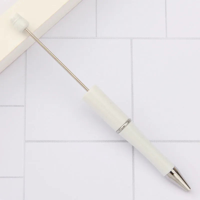 Creative ballpoint pen with multicoloured spinning plastic beads on a steel wire frame.