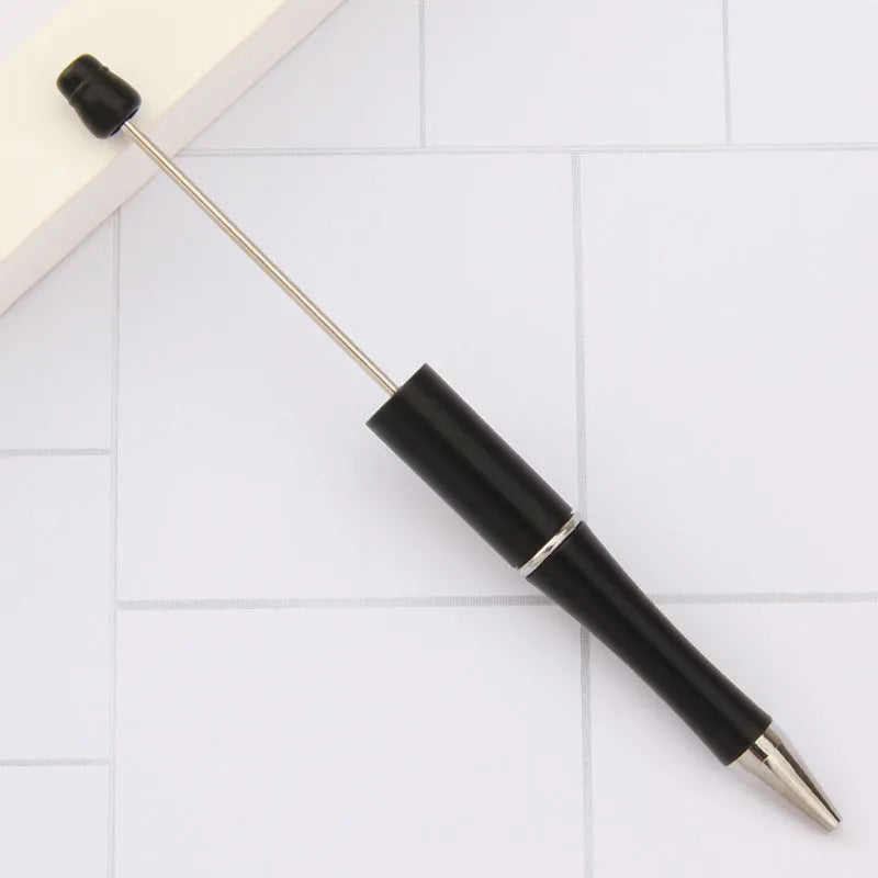 Creative ballpoint pen with multicoloured spinning plastic beads on a steel wire frame.