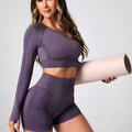 Women's black high waist yoga suit with long sleeve top and tight-fitting trousers on a mannequin.