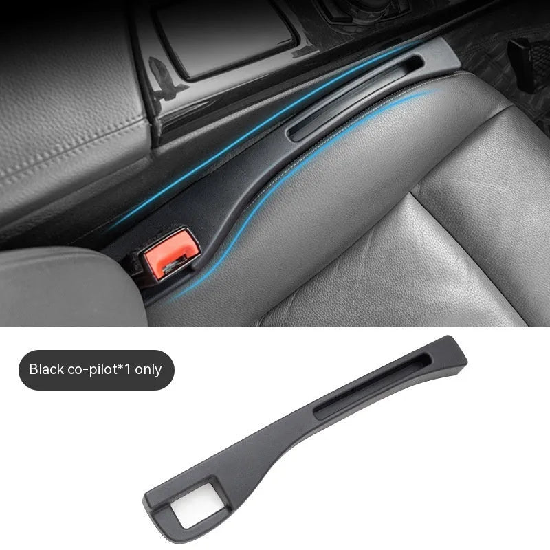 Black car gap storage box with handle positioned between car seats
