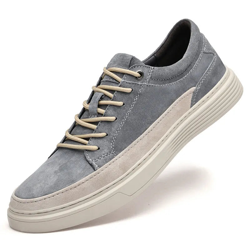 Men's gray casual skate shoes with pigskin leather upper and rubber sole on a white background.