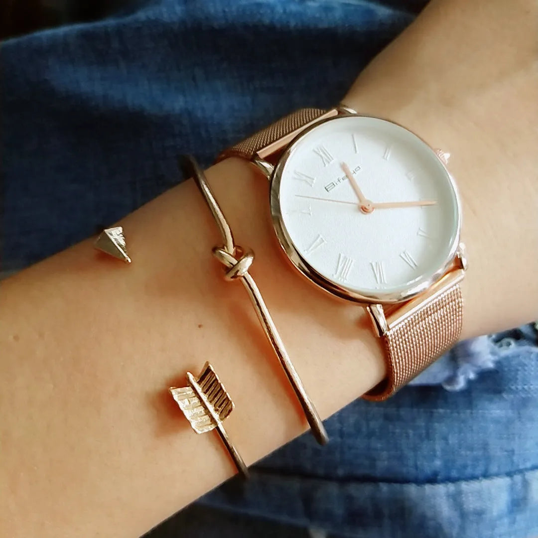 Gold-toned vintage women's cuff bracelet with an intricate arrow knot design.