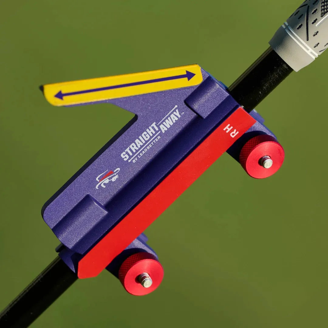 A plastic golf swing plane simulator training aid on a green background.