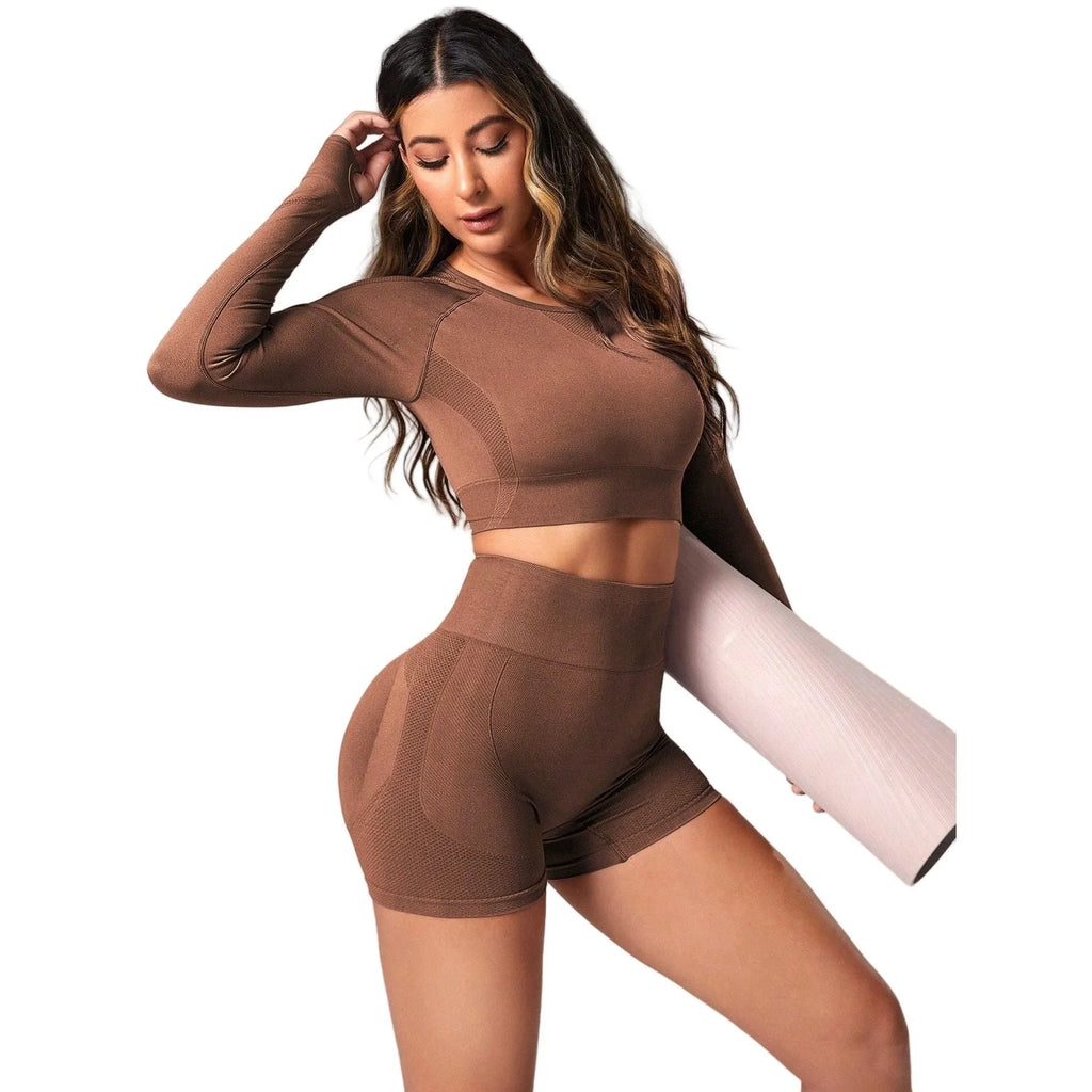 Women's black high waist yoga suit with long sleeve top and tight-fitting trousers on a mannequin.