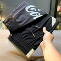 Black men's ultra-thin cotton cropped trousers with elasticated ankle banding.