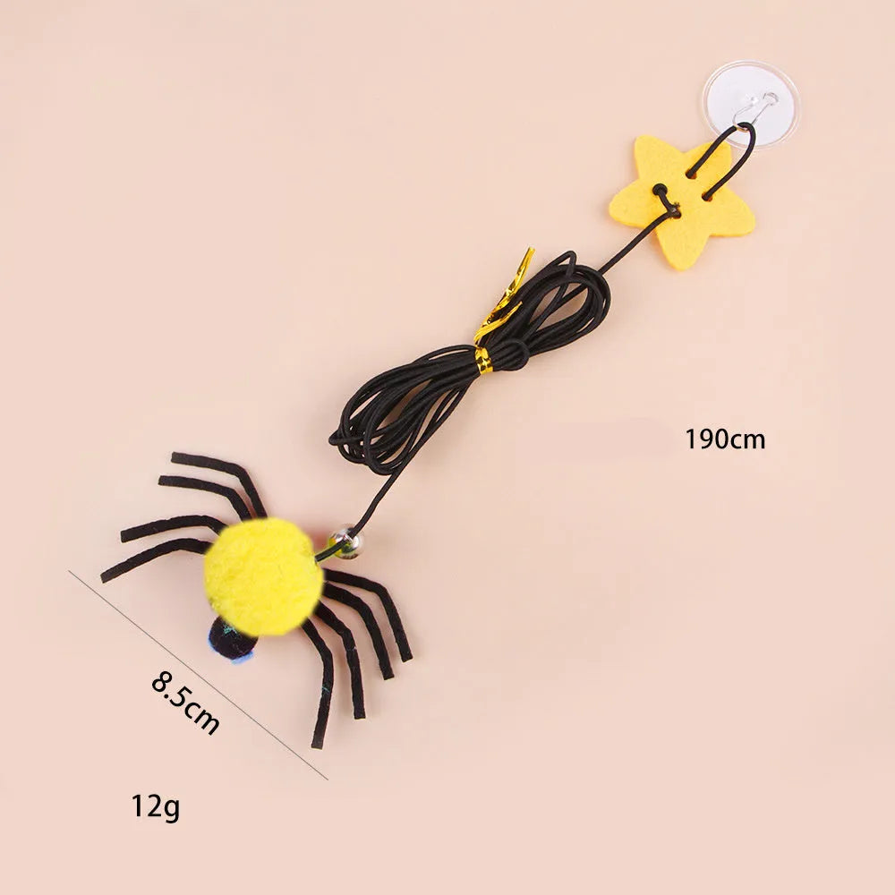 Cat door hanging toy with elastic rope, feather, bell, and spider design in red colour