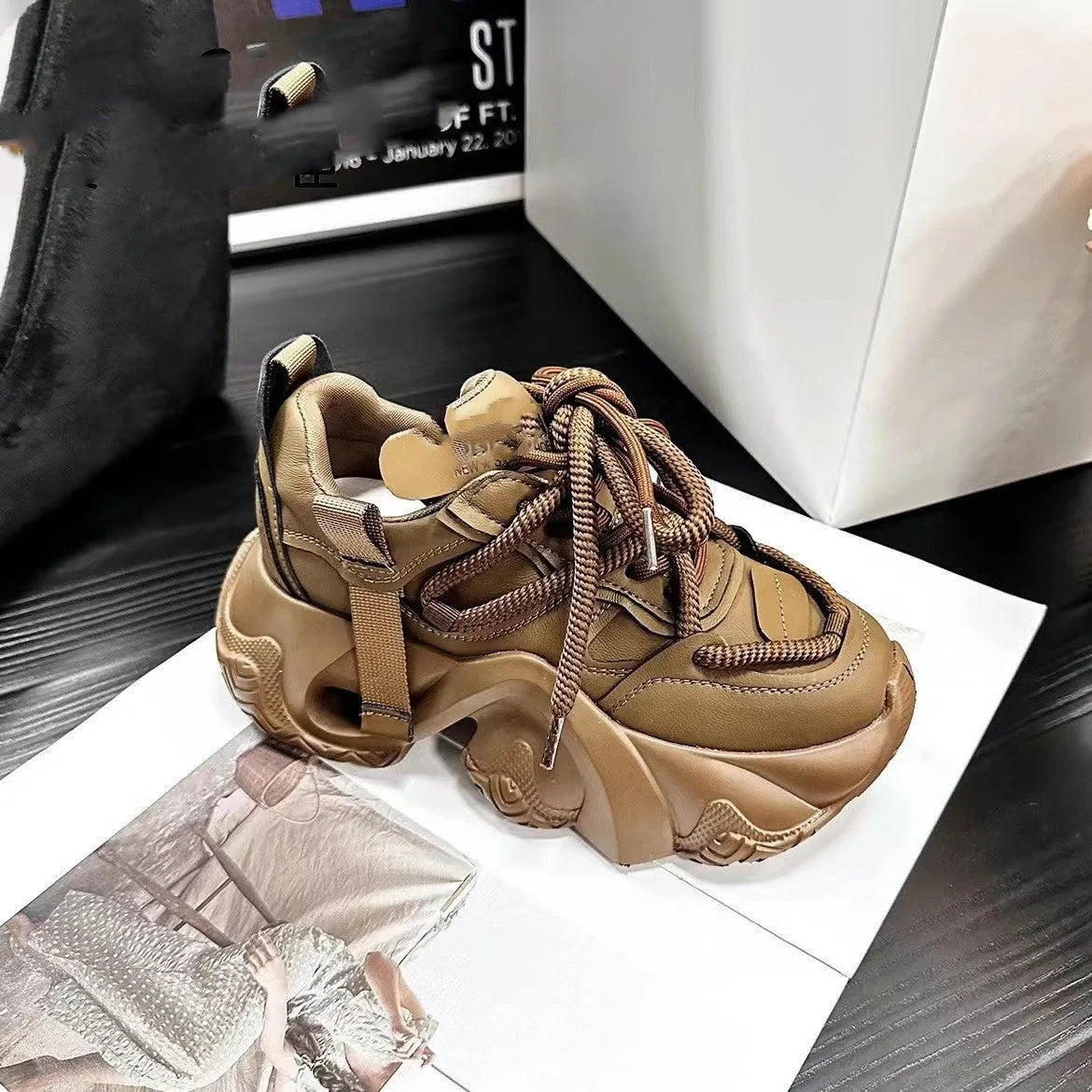 Women's creamy white platform sneakers with wedge heel, cross-strap detail, and lace-up front.