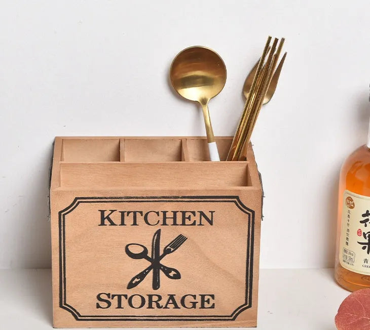 Natural wooden kitchen storage box with internal grid dividers for organising knives, forks, and chopsticks.
