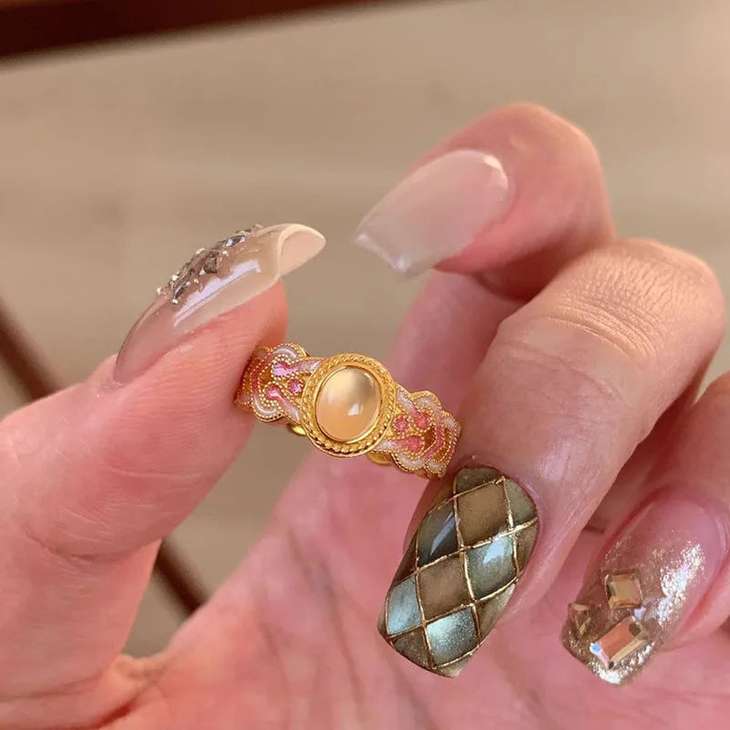 Geometric pink crystal enamel open ring for women on a copper band with gold plating.