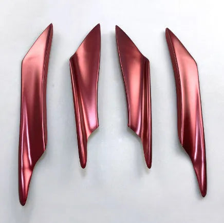 Set of four black ABS plastic bumper blade spoilers for car modification on a white background.