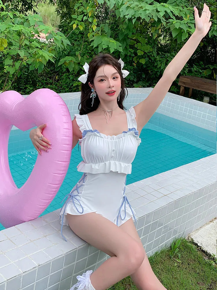 Milky White women's backless one-piece swimsuit on a hanger