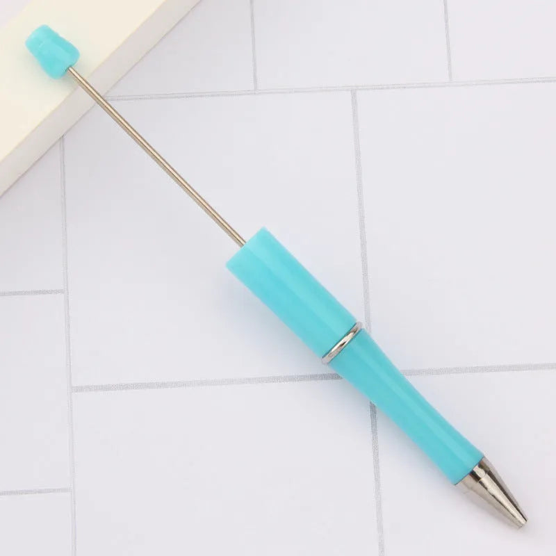 Creative ballpoint pen with multicoloured spinning plastic beads on a steel wire frame.