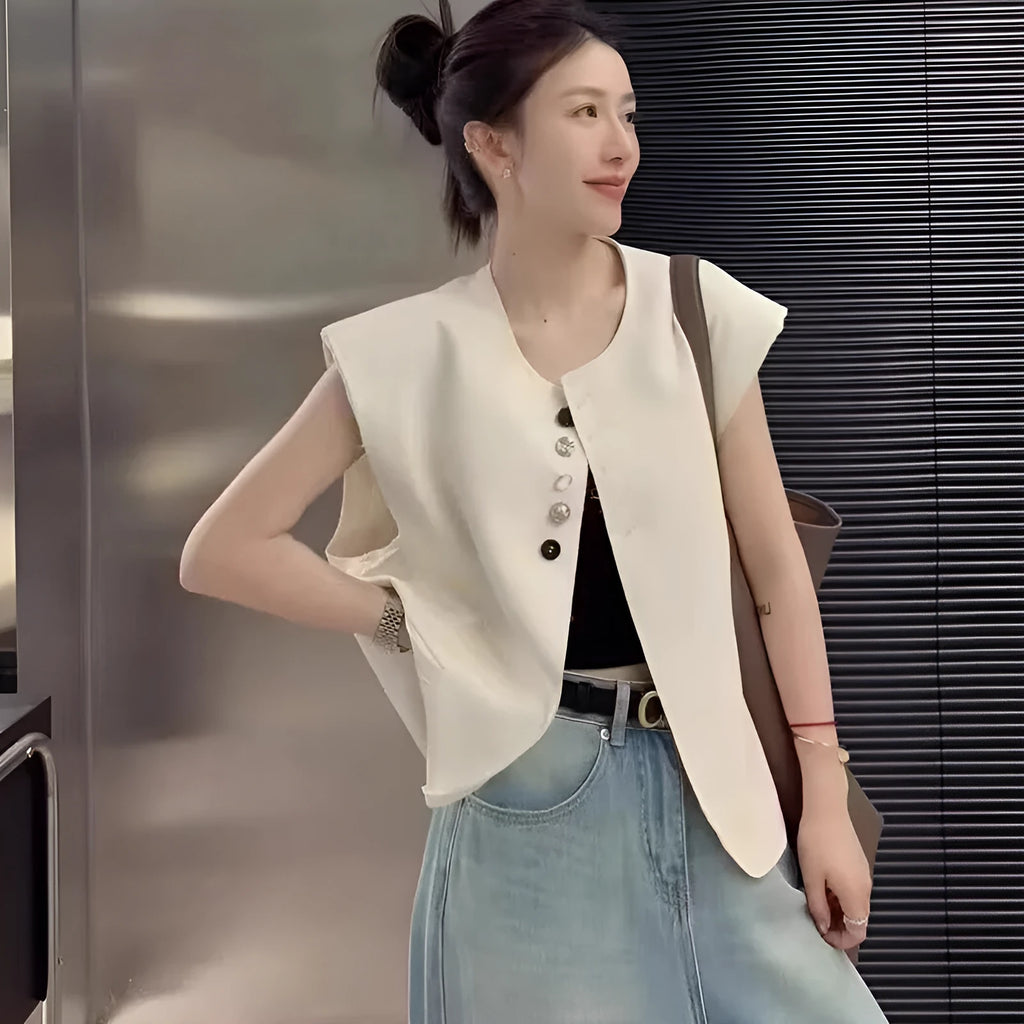 Women's loose fit polyester vest in milky white and black colours with pocket details.