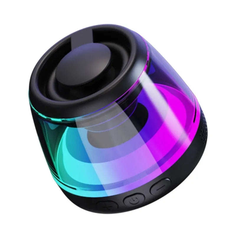 Black and white portable Bluetooth speaker with magnetic base and ambient lighting on desktop