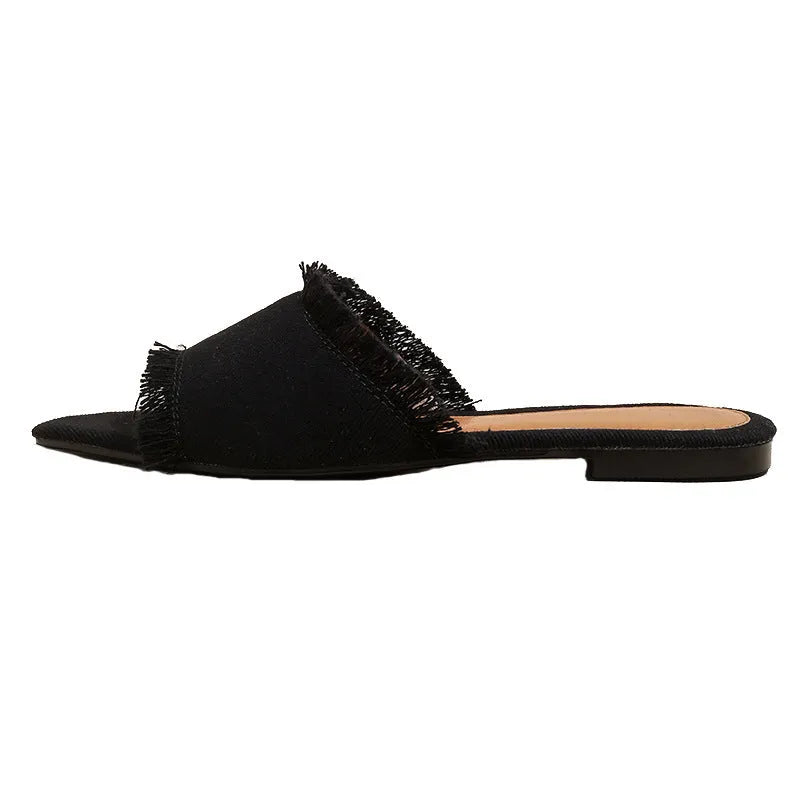 Women's denim flat slippers with tassel detail and leather lining in various colours.