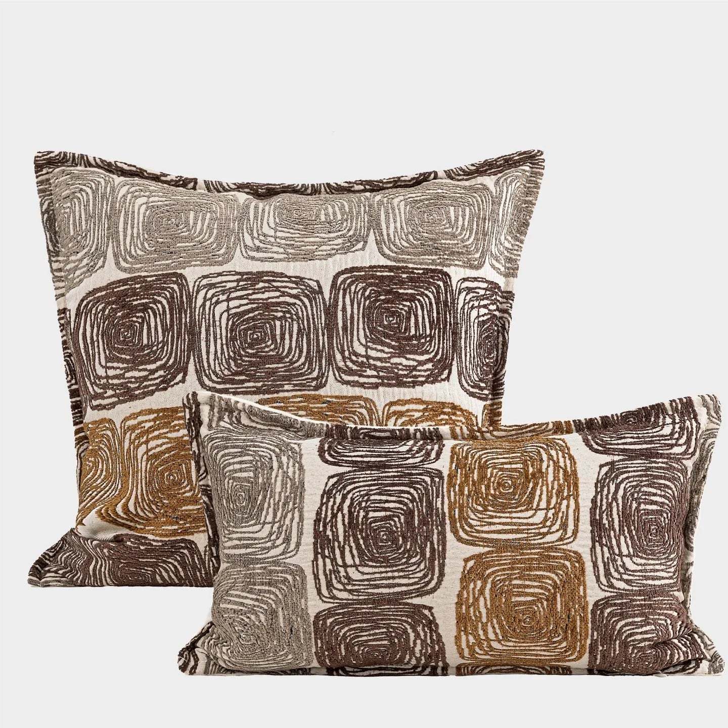 Abstract geometric coil pattern pillow cover in cream and coffee colours on textured fabric