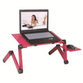 Red folding metal bed table with extended strap and cooling fan, holding a laptop.