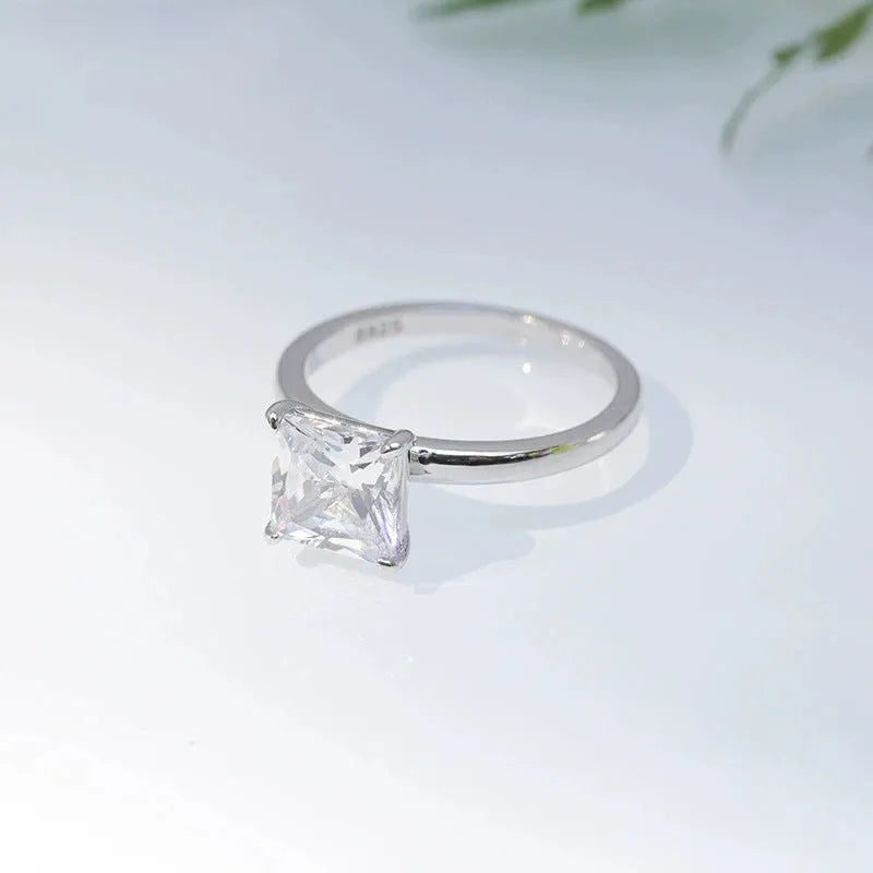 Simple geometric 925 silver ring for women in gold, rose gold, or silver colour on a grey background.
