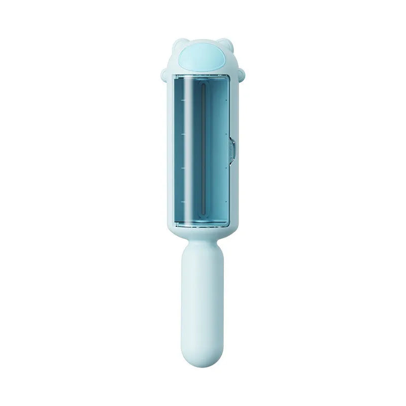 Blue reusable pet hair remover roller with self-cleaning base on a fabric sofa.
