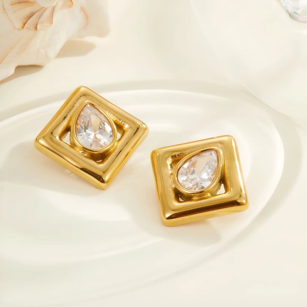 Pair of gold-coloured stainless steel stud earrings with geometric water drop zircon stone inlays.