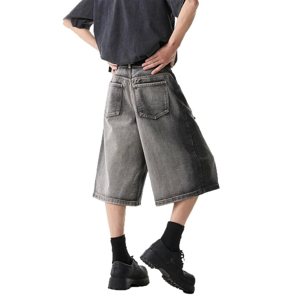 Grey loose-fit denim shorts with a water-washed finish and distressed hole details.