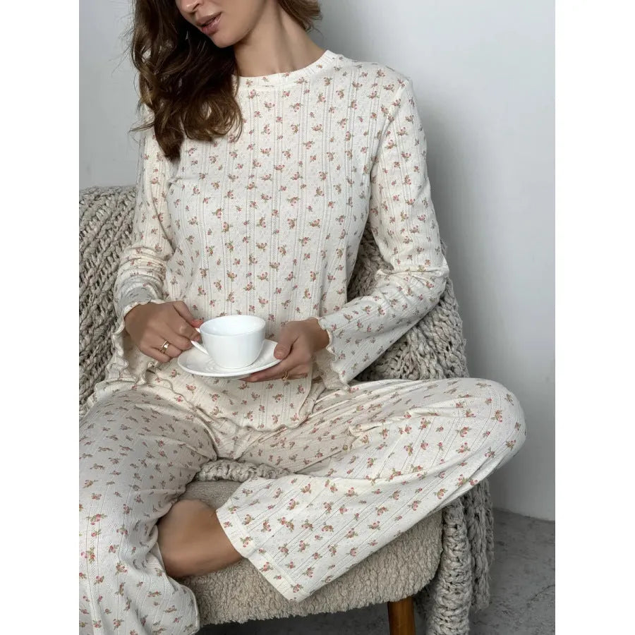 White floral print women's loungewear suit with bell sleeve top and wide-leg trousers.