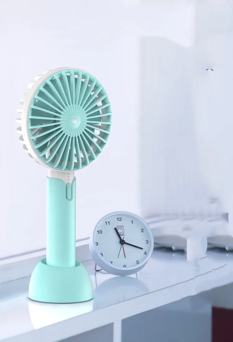 Blue mini USB electric fan with oscillation head and 3 speed controls on desk