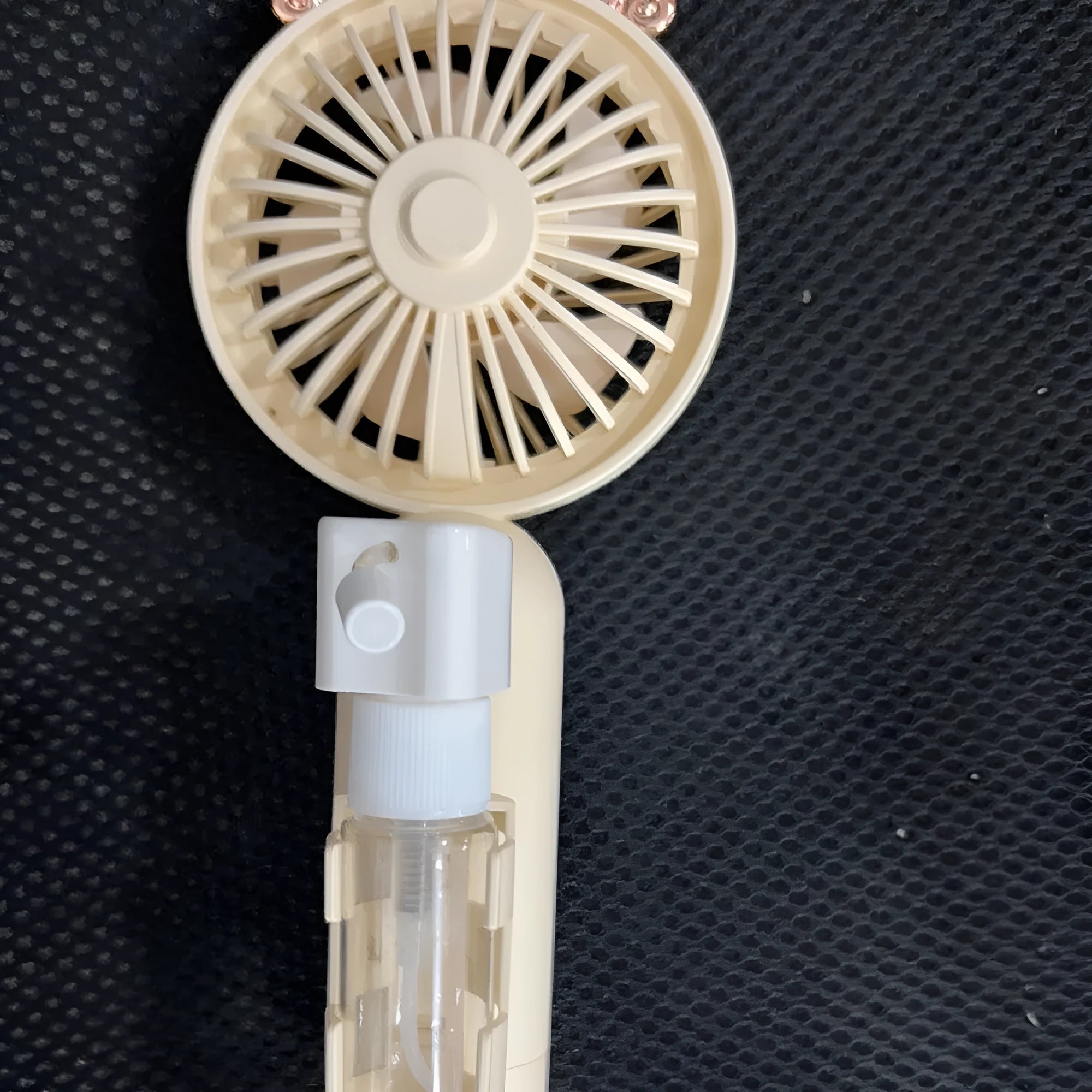 Colourful plastic USB rechargeable personal fan shown in apricot, blue, green, orange, and pink nozzle options.