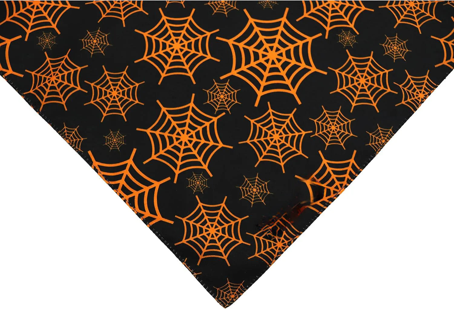 Reversible Halloween dog bandana showing pumpkin and spider web designs in black and orange colours with adjustable neck closure