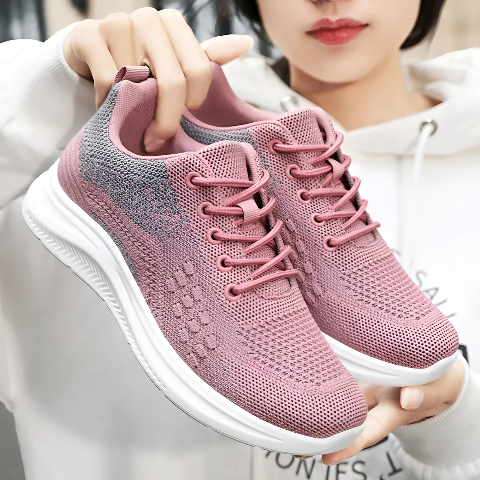 Women's black mesh sneakers with round toe and lace-up design on white background