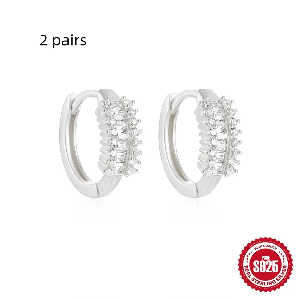 Sterling silver geometric stud earrings with small round diamond detailing in gold and silver electroplated finishes