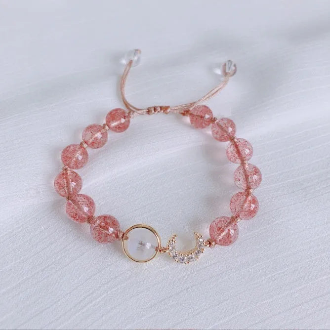 Adjustable strawberry quartz bracelet with Hetian jade peach blossom charm on wrist