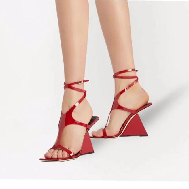 Women's black high heel sandals with square toe and ankle strap button fastening on a white background.