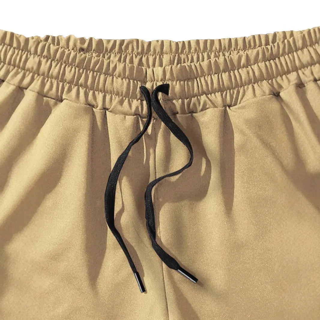 Men's khaki sports shorts with coconut print pattern showing straight cut and micro-elastic polyester fabric