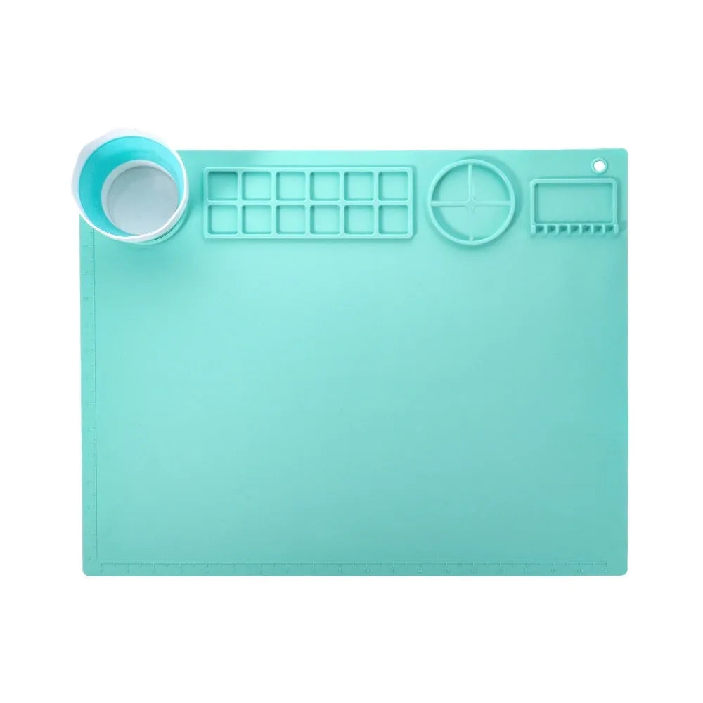 Light blue silicone painting mat with two round bowls on a 50cm by 40cm rectangular surface.