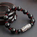 Hand-woven black agate dzi bead bracelet with geometry pattern on wrist